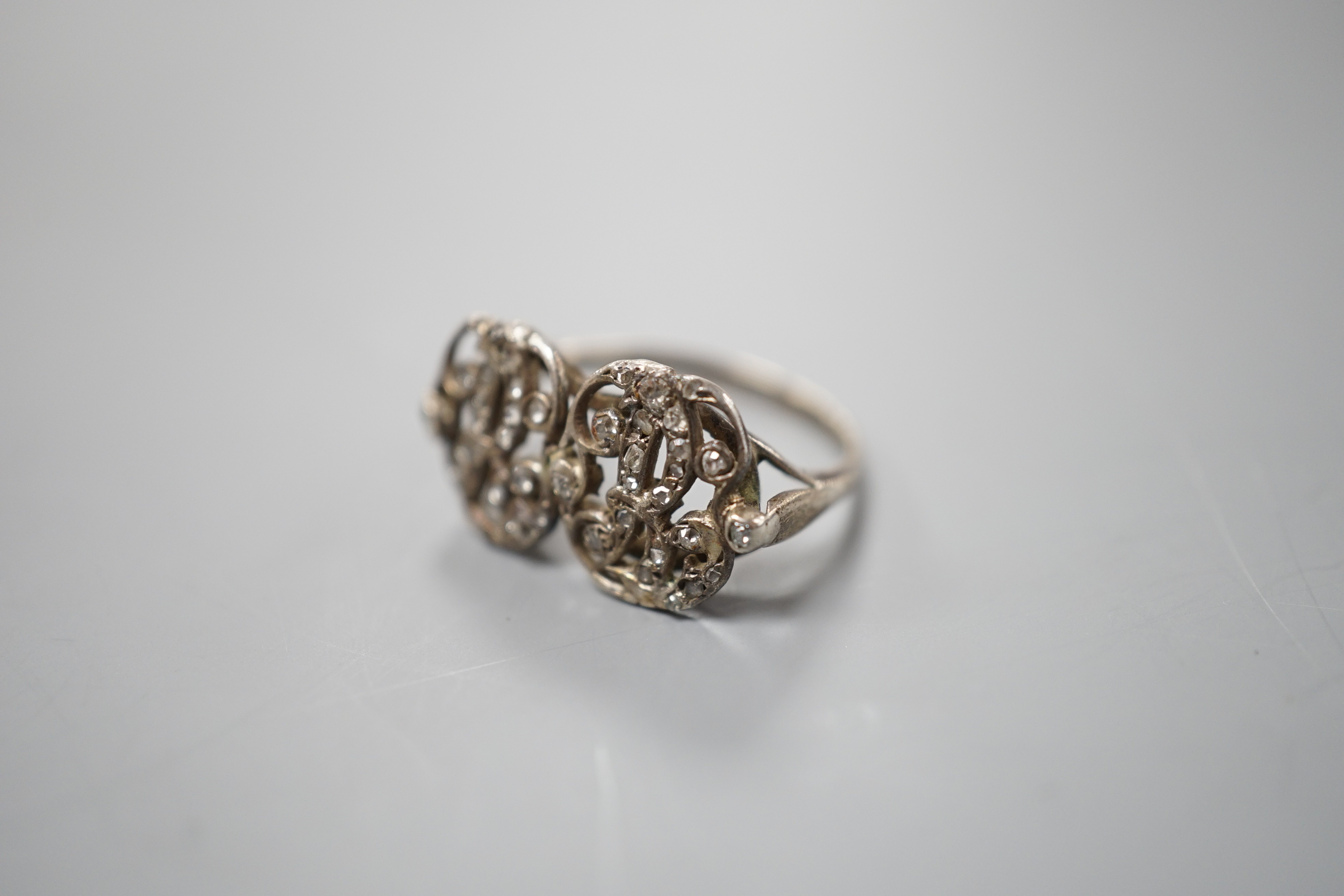 A 19th century white metal and rose cut diamond chip set monogram? ring, size L, gross weight 3 grams.